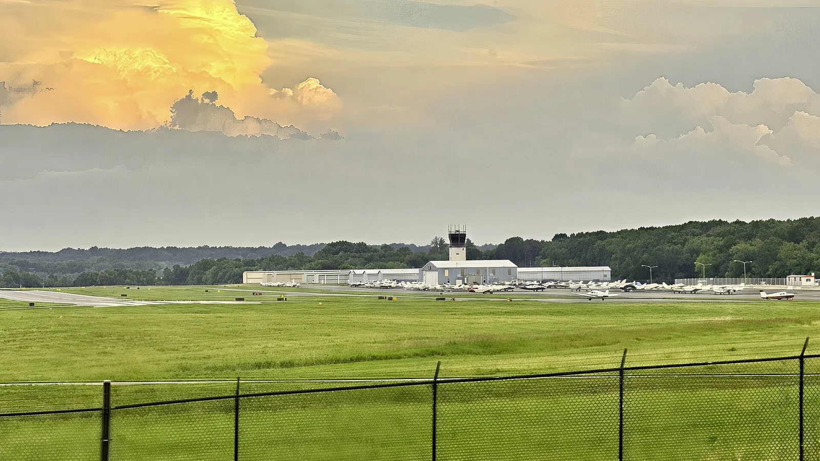 Washington Manassas Airport seen across the airfield, with the existing control tower above the terminal.