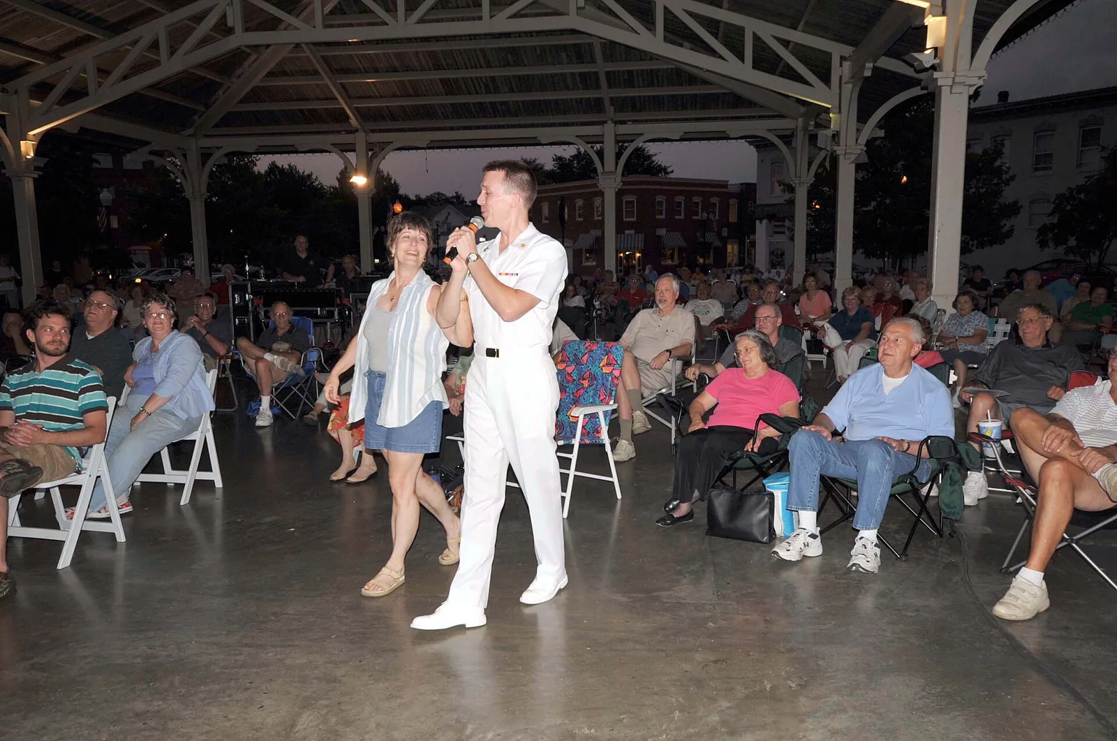 A singer performs for a seated crowd under the Harris Pavilion in downtown Manassas, home of one of the Fall Jubilee's two stages.