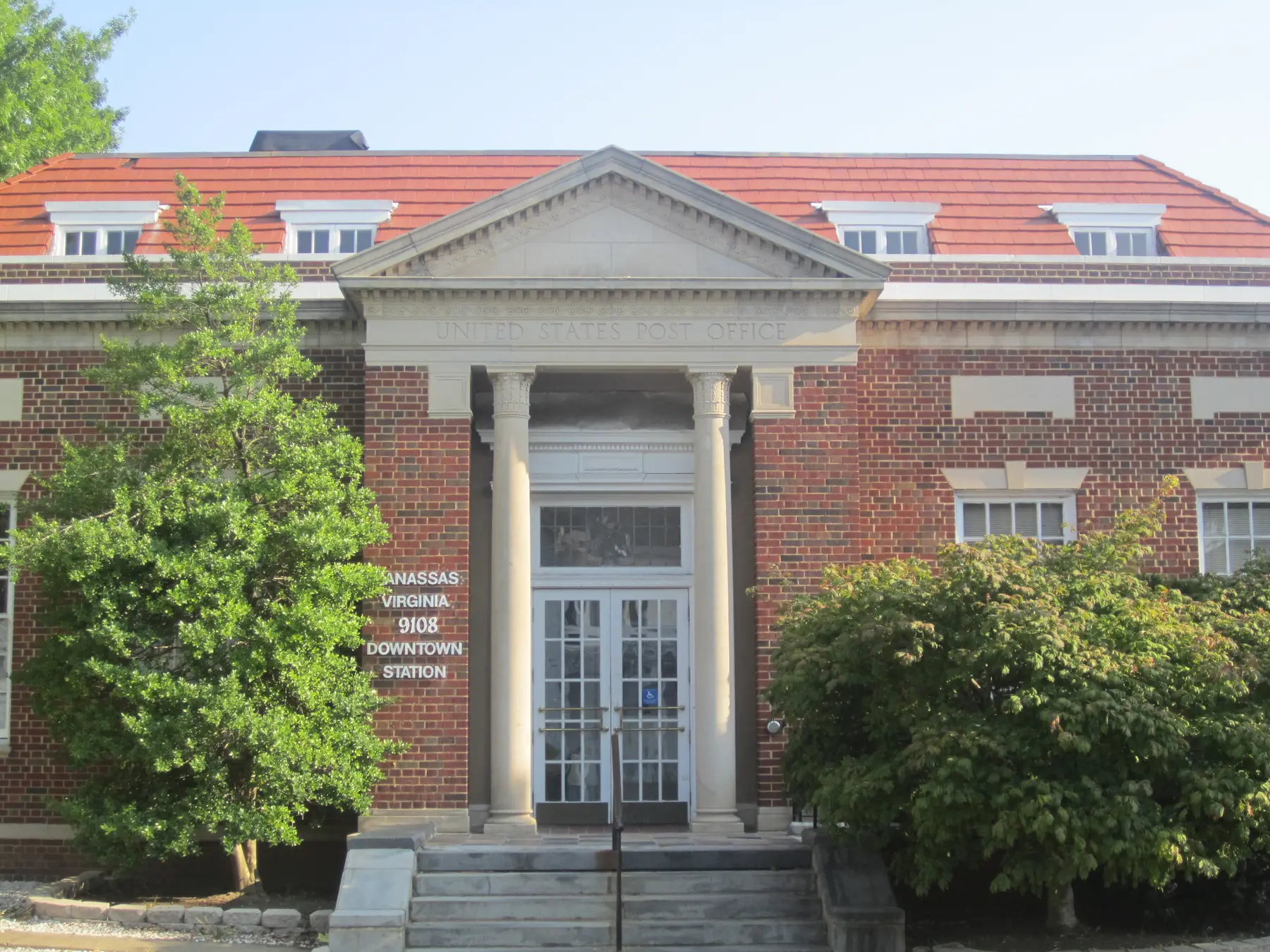 The Manassas Downtown Station post office, a red-brick building with a columned entrance in Historic Downtown Manassas.