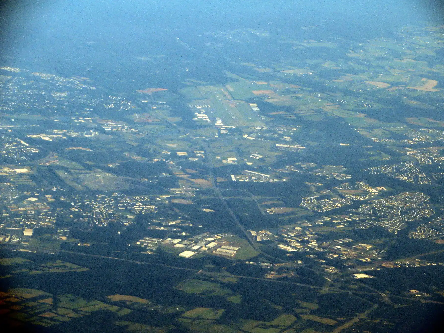 Manassas seen from the air, with the runways of Manassas Regional Airport among the city's neighborhoods and business parks.