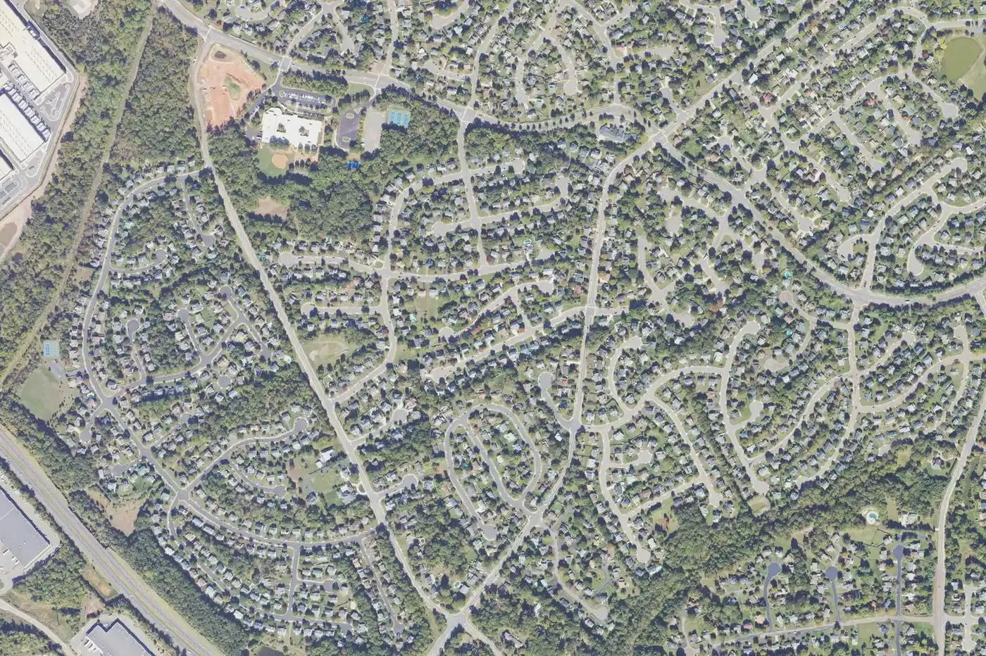 An aerial view of Lee Manor in southwest Manassas, with detached homes on curving streets between Godwin Drive and Hastings Drive.
