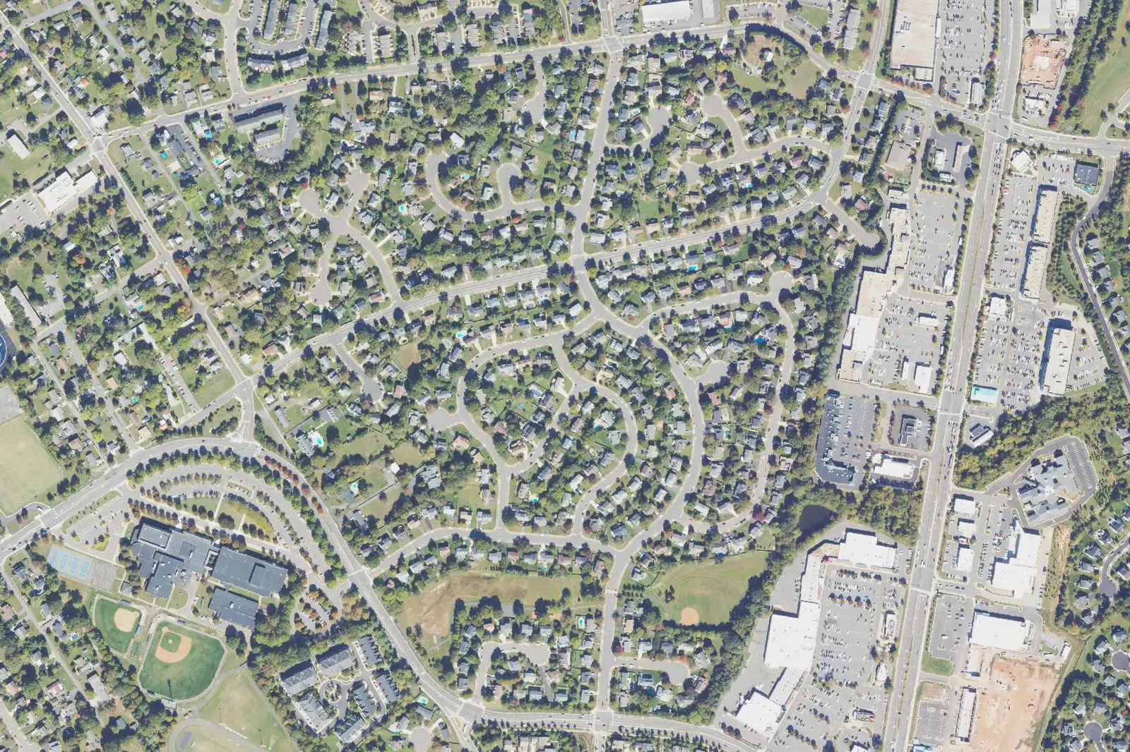 An aerial view of Oakenshaw in east Manassas, with Grace E. Metz Middle at lower left and shopping centers along the right edge.