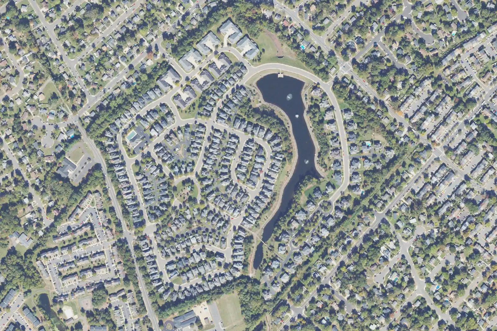 An aerial view of Sumner Lake in north Manassas, with the lake curving through the middle of the neighborhood.