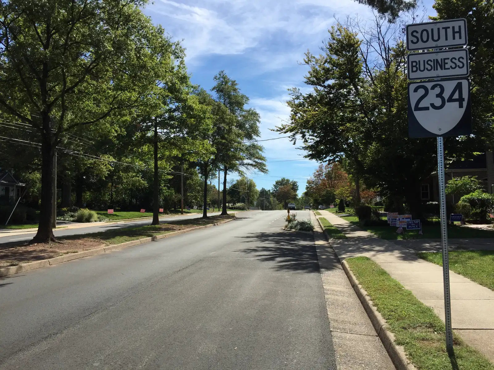 Sudley Road (Route 234 Business) at Stuart Avenue in Manassas, a tree-lined stretch through the older neighborhoods just north of downtown.