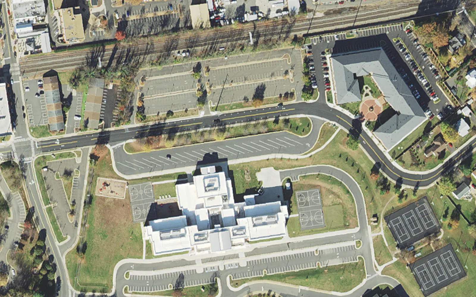 The Baldwin school building on Eagle Way in Manassas from the air, with the railroad and downtown parking lots to the north.